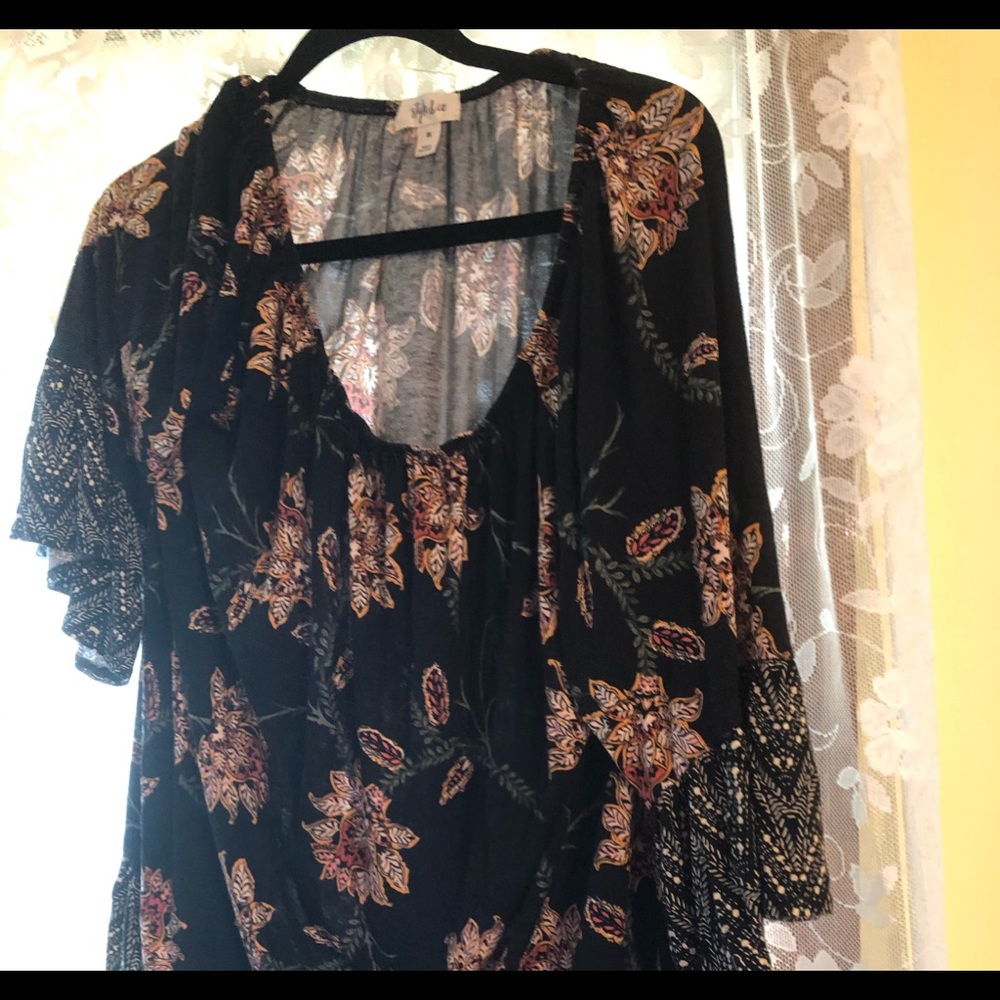 Multicolored top with black background.